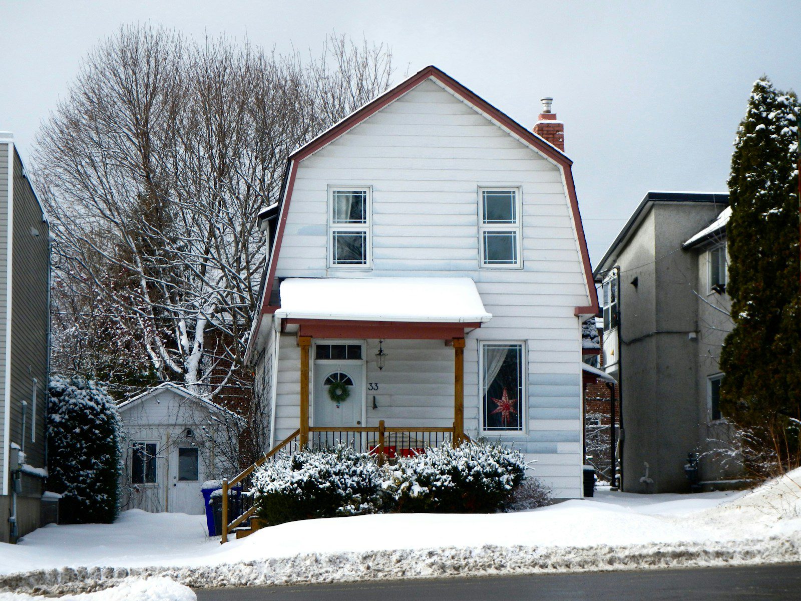 white and brown wooden house near bare trees during daytime