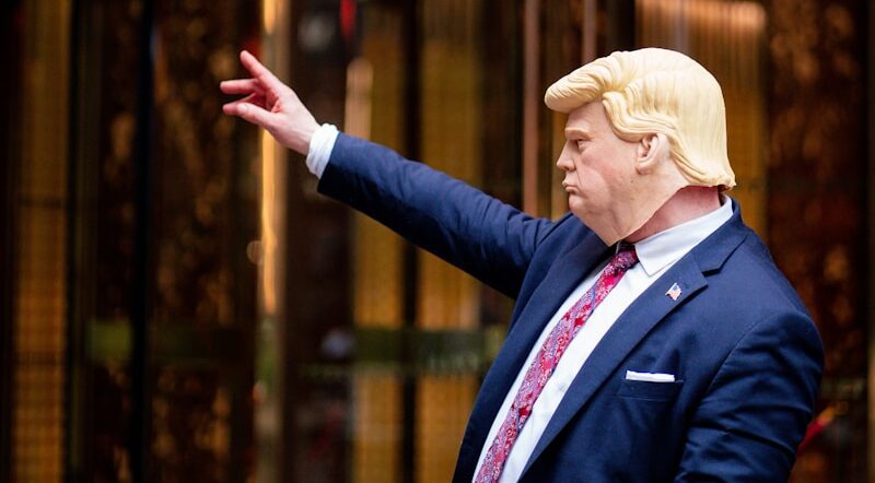 A Trump clown addressing an angry crowd — an image that raises the question of the worth of wealth and power.