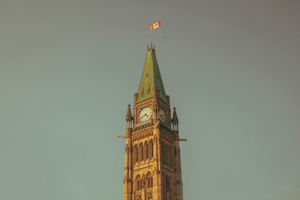 a tall clock tower with a flag on top