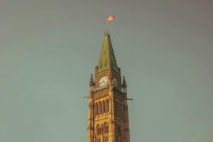 a tall clock tower with a flag on top