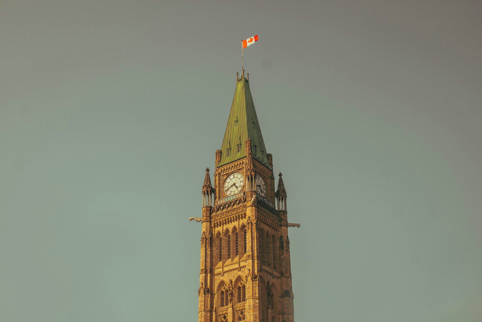 a tall clock tower with a flag on top