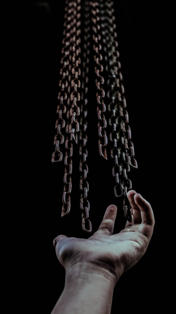 man's hand and chains representing the erosion of freedoms