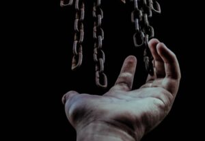 man's hand and chains representing the erosion of freedoms