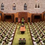 Empty House of Commons chamber where conservative policy debates focus on priorities