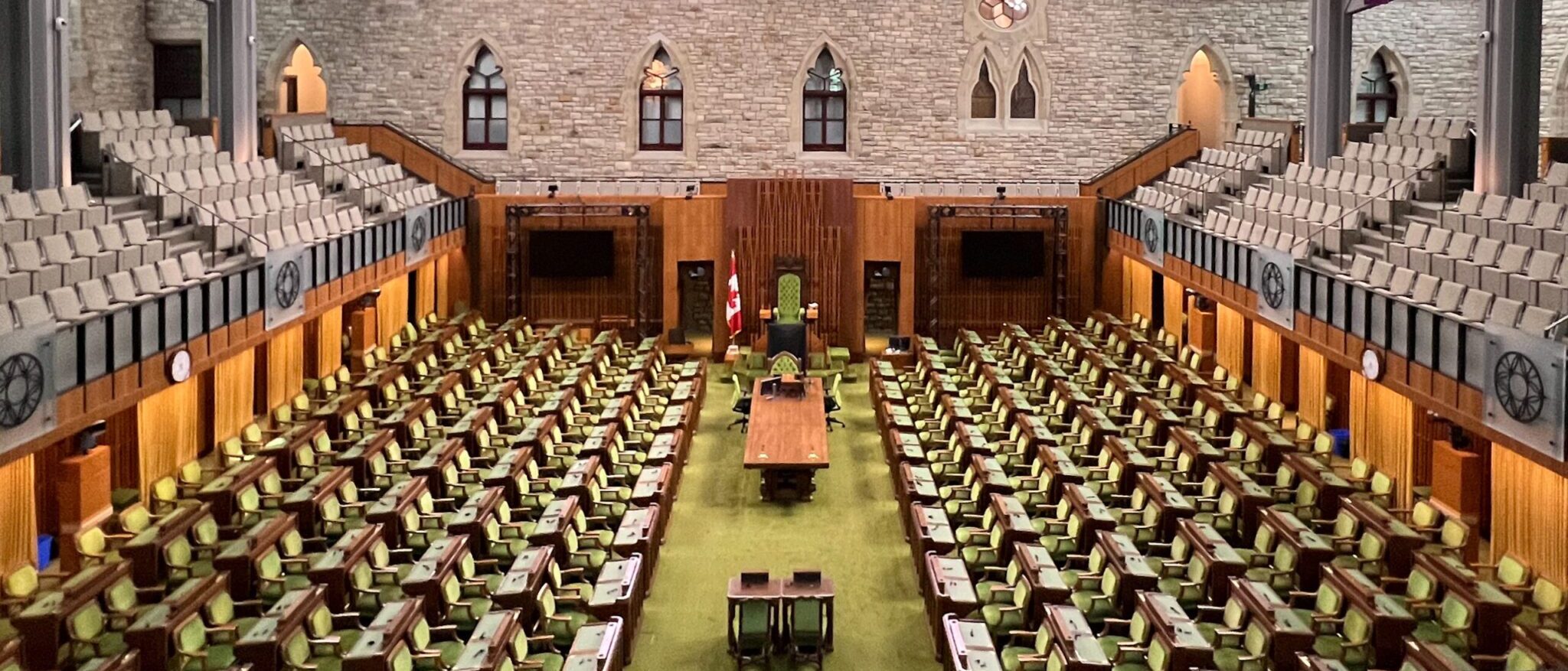 Empty House of Commons chamber where conservative policy debates focus on priorities