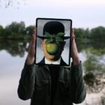 Man hold up deepfakes on ipad