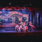 crowd of people watching a stage performance in the theater