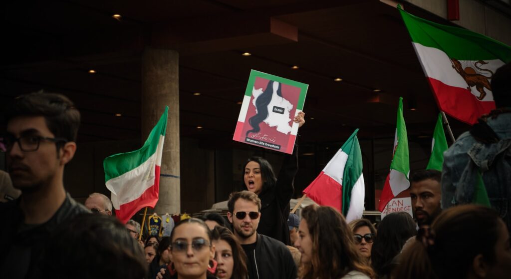 Crowd of protesters holding flags during the Iran protests