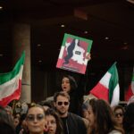 Crowd of protesters holding flags during the Iran protests
