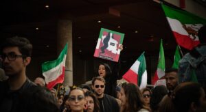 Crowd of protesters holding flags during the Iran protests