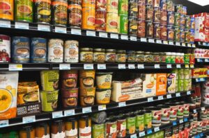 Grocery store aisle in Canada showing shelf prices and packaged foods, illustrating ongoing grocery costs and the debate over the gst rebate