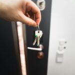 A person is holding a key to a door