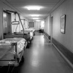 grayscale photo of hospital bed