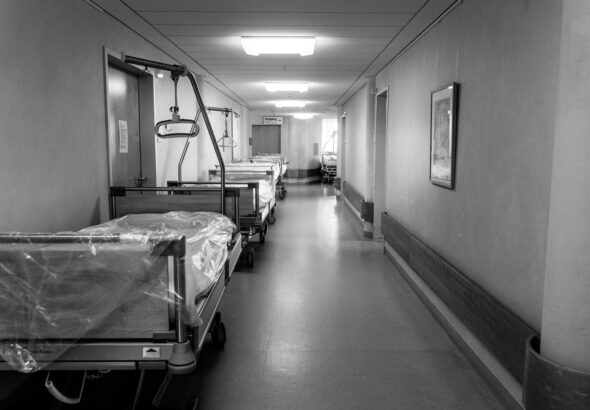 grayscale photo of hospital bed
