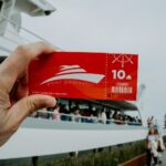 A person holds a cruise ticket.