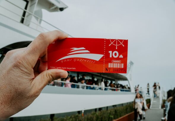 A person holds a cruise ticket.