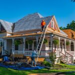 Roofers replace the roof of a historic home in Weatherford, Texas.