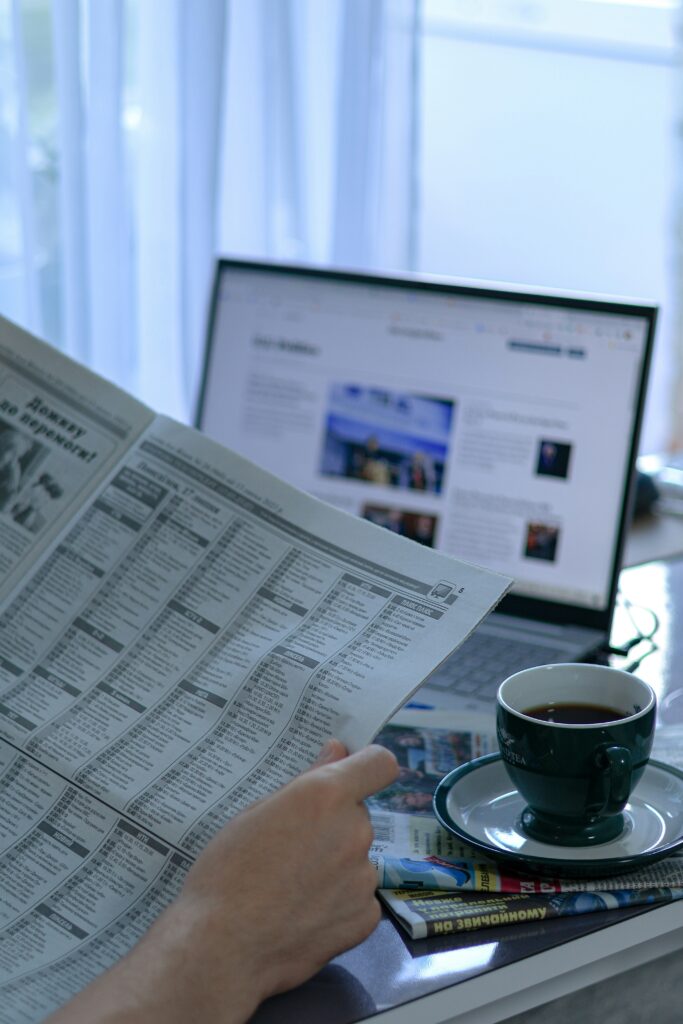 Morning newspaper and laptop representing the day's news briefing