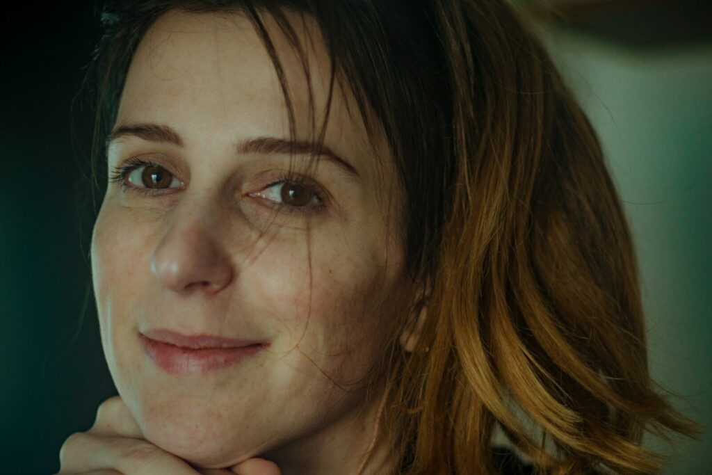 A thoughtful woman looking forward in warm, natural lighting, representing modern menopause care in Ontario.