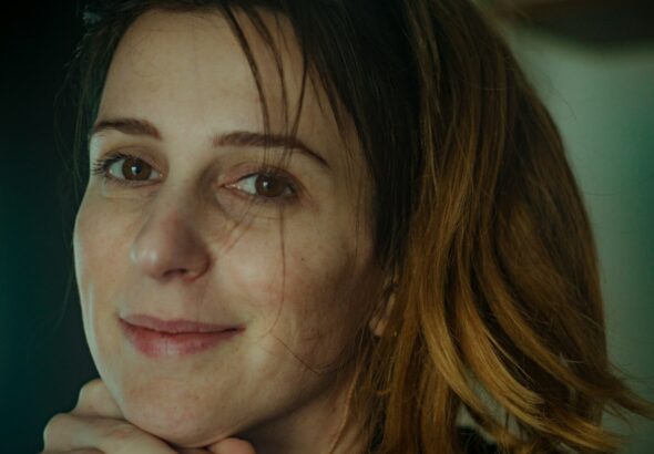 A thoughtful woman looking forward in warm, natural lighting, representing modern menopause care in Ontario.